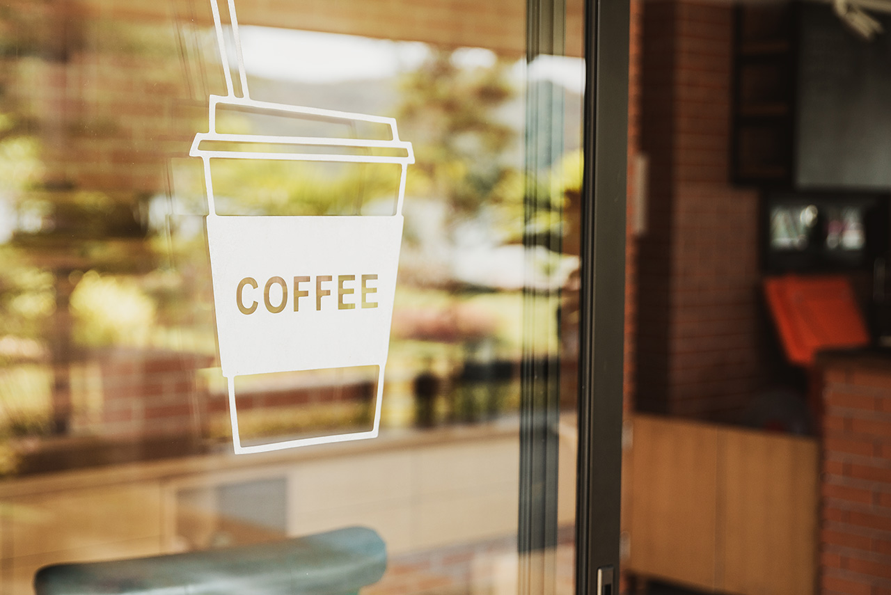 Neighborhood Luxury-coffee-shop-sign-on-the-glass-door.-